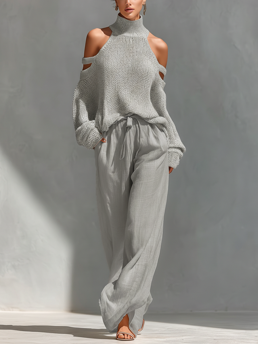Conjunto de mujer con top de punto beige de cuello alto y hombros al descubierto, y pantalones de pierna ancha